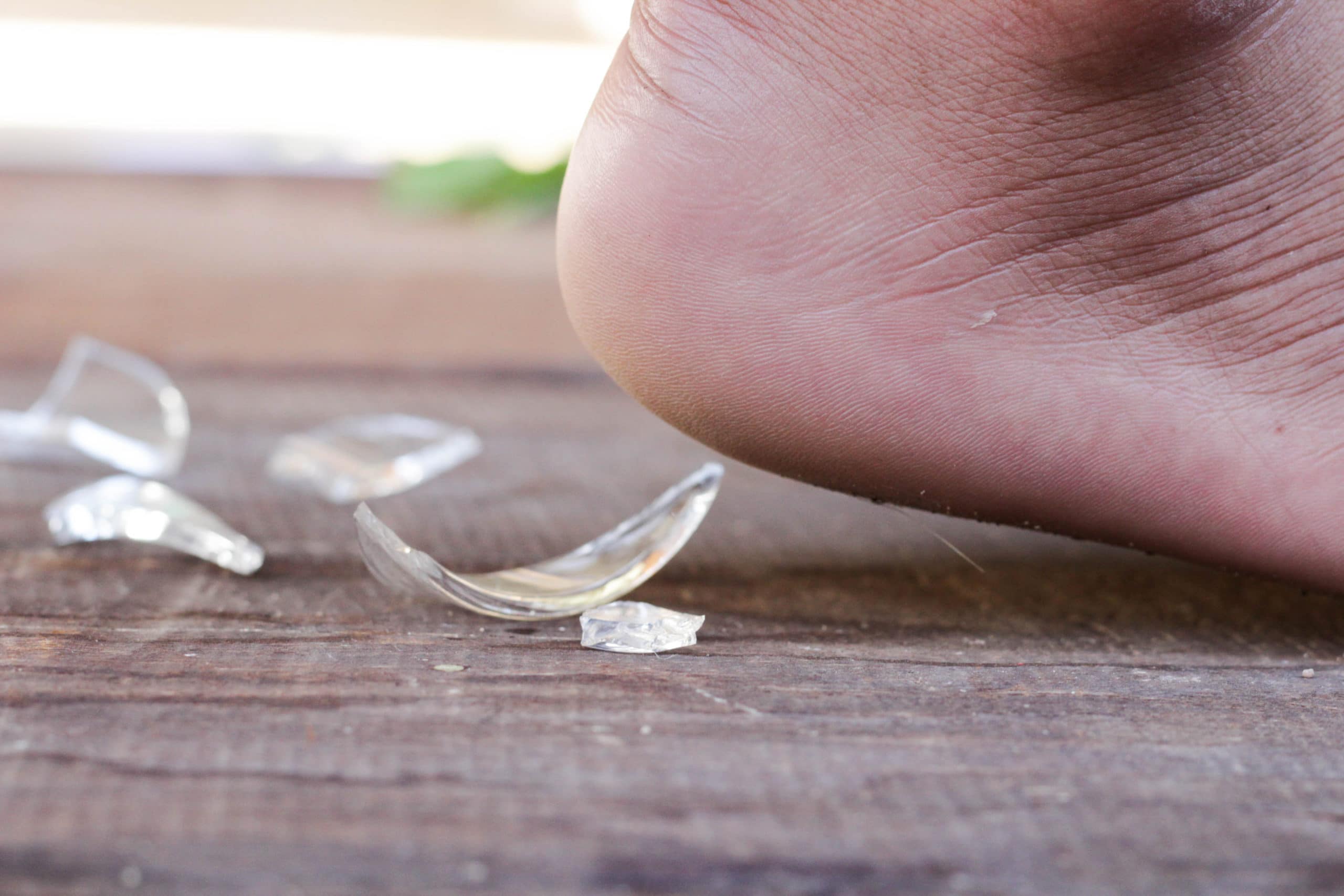 Person about to step on glass